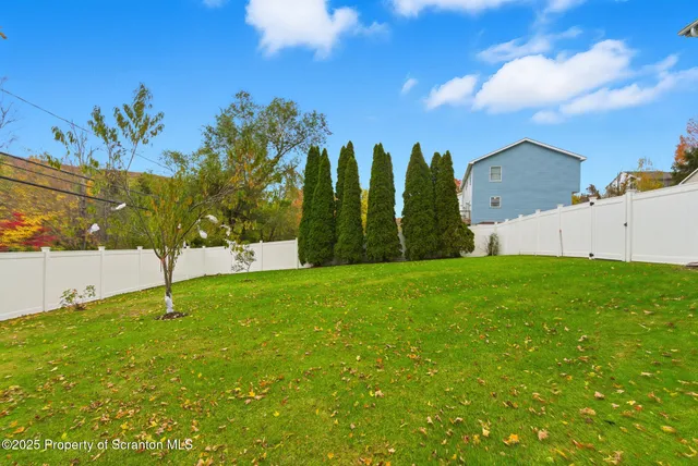 a picture of a wall with a white table and chairs