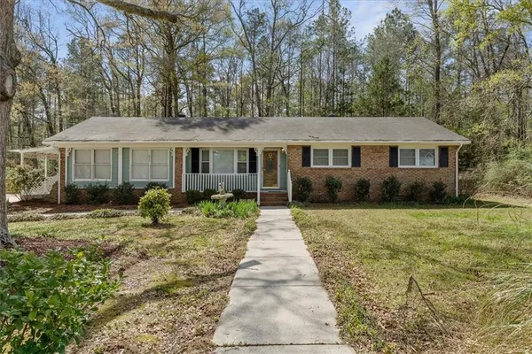 a front view of a house with a garden