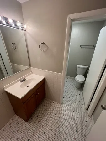 a bathroom with a sink mirror and toilet