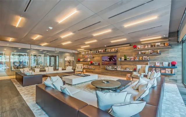 a dining room with stainless steel appliances granite countertop a table chairs and a sink