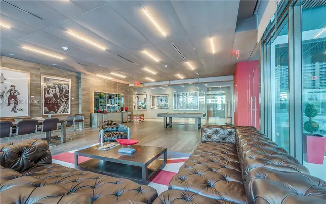 a living room with furniture and a floor to ceiling window