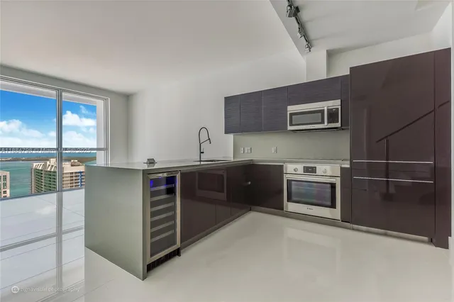 a kitchen with stainless steel appliances and cabinets