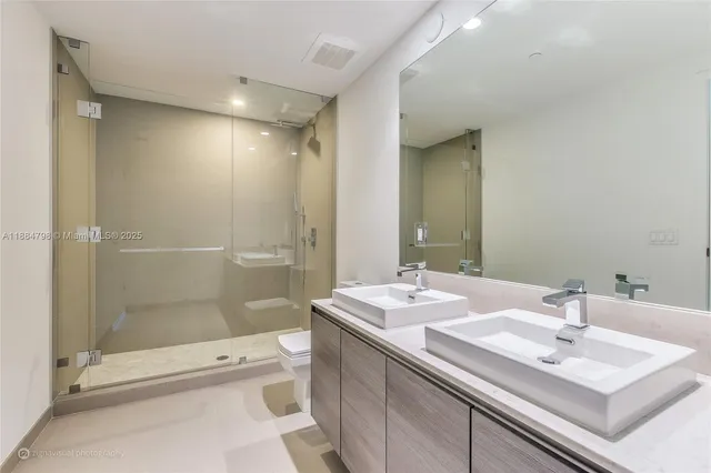 a bathroom with a sink double vanity and shower
