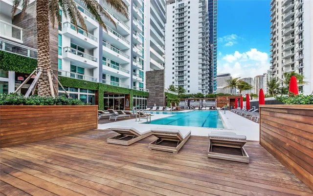 a view of a patio with swimming pool and table and chairs