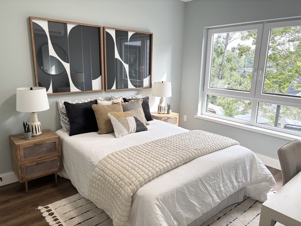 1391 Main Street, Unit 305 Walpole, MA 02081 - Photo 15 of 31 a bedroom with a bed and wooden floor