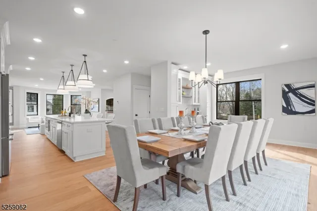 a dining room with furniture a chandelier and window