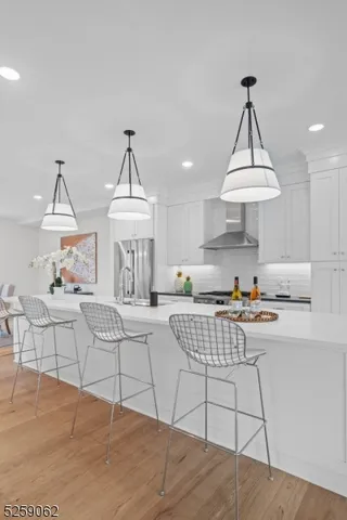 a living room with furniture a table and a chandelier