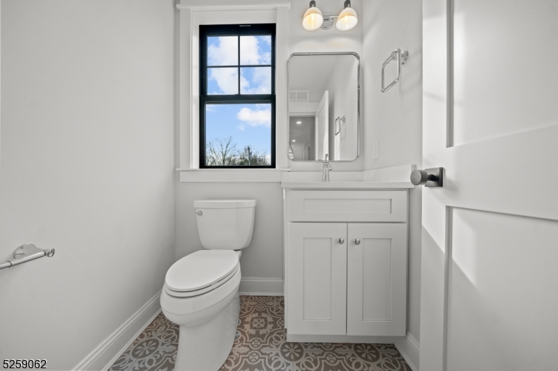 147 Center Avenue, Unit 17 Old Tappan, NJ 07675 - Photo 16 of 48 a bathroom with a toilet a sink and a mirror