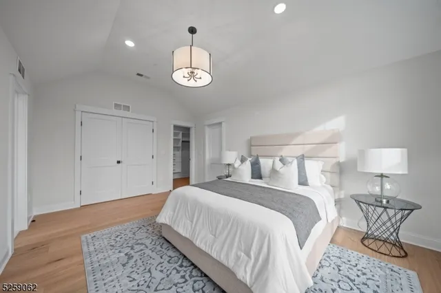 a bedroom with a bed and a lamp on table