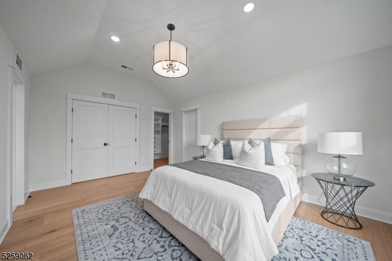 147 Center Avenue, Unit 17 Old Tappan, NJ 07675 - Photo 22 of 48 a bedroom with a bed and a lamp on table