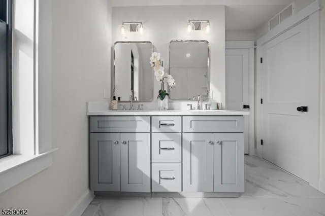 a bathroom with a double vanity sink and mirror