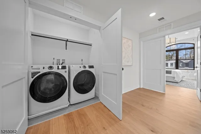 a view of a hallway with washer and dryer