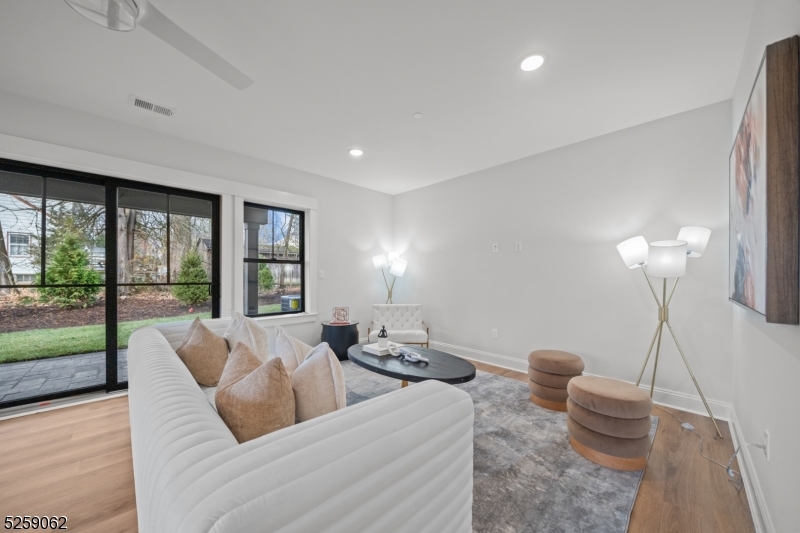 147 Center Avenue, Unit 17 Old Tappan, NJ 07675 - Photo 37 of 48 a living room with furniture and a floor to ceiling window