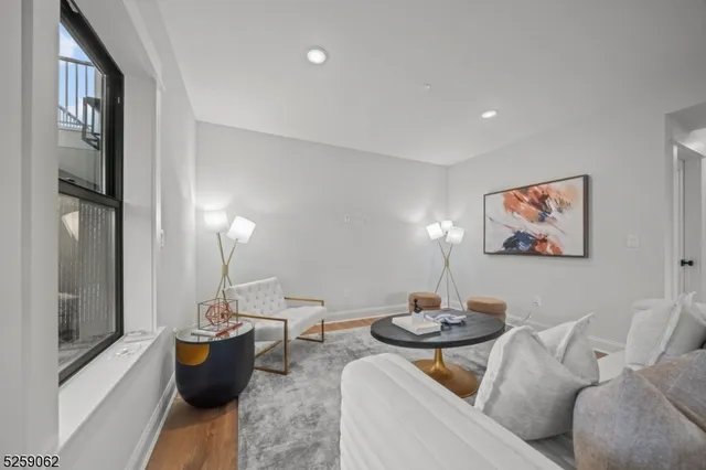 a living room with furniture a lamp and a potted plant