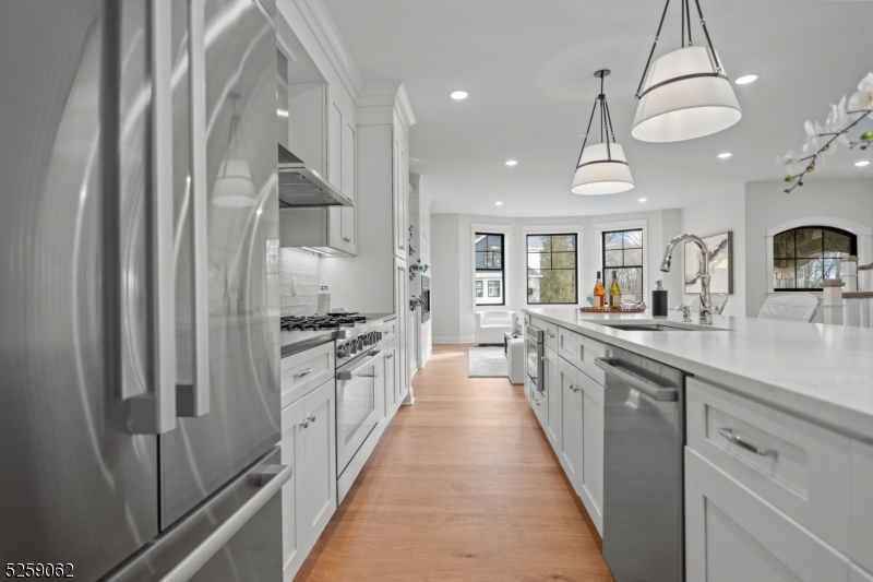 147 Center Avenue, Unit 17 Old Tappan, NJ 07675 - Photo 8 of 48 a large kitchen with stainless steel appliances a sink and cabinets