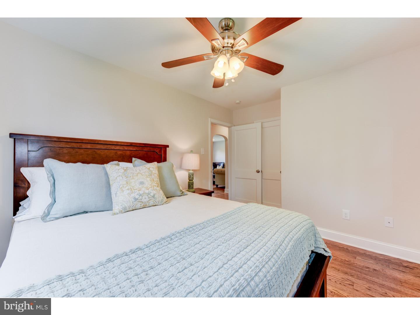2224 Avon Road Ardmore, PA 19003 - Photo 12 of 23 a bedroom with a large bed and a chandelier