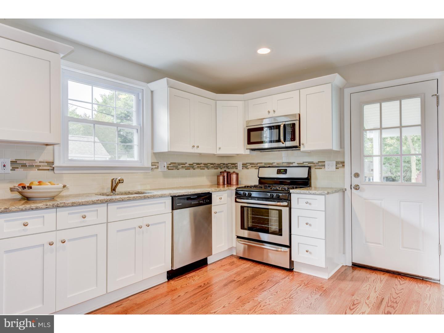 2224 Avon Road Ardmore, PA 19003 - Photo 9 of 23 a kitchen with granite countertop a stove a sink and a microwave