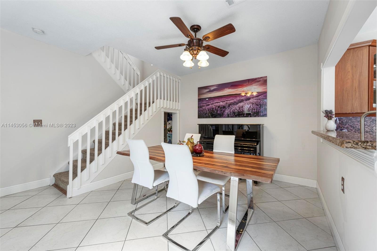 4175 Tree Top Road Cooper City, FL 33026 - Photo 12 of 39 a dining room with furniture and a chandelier