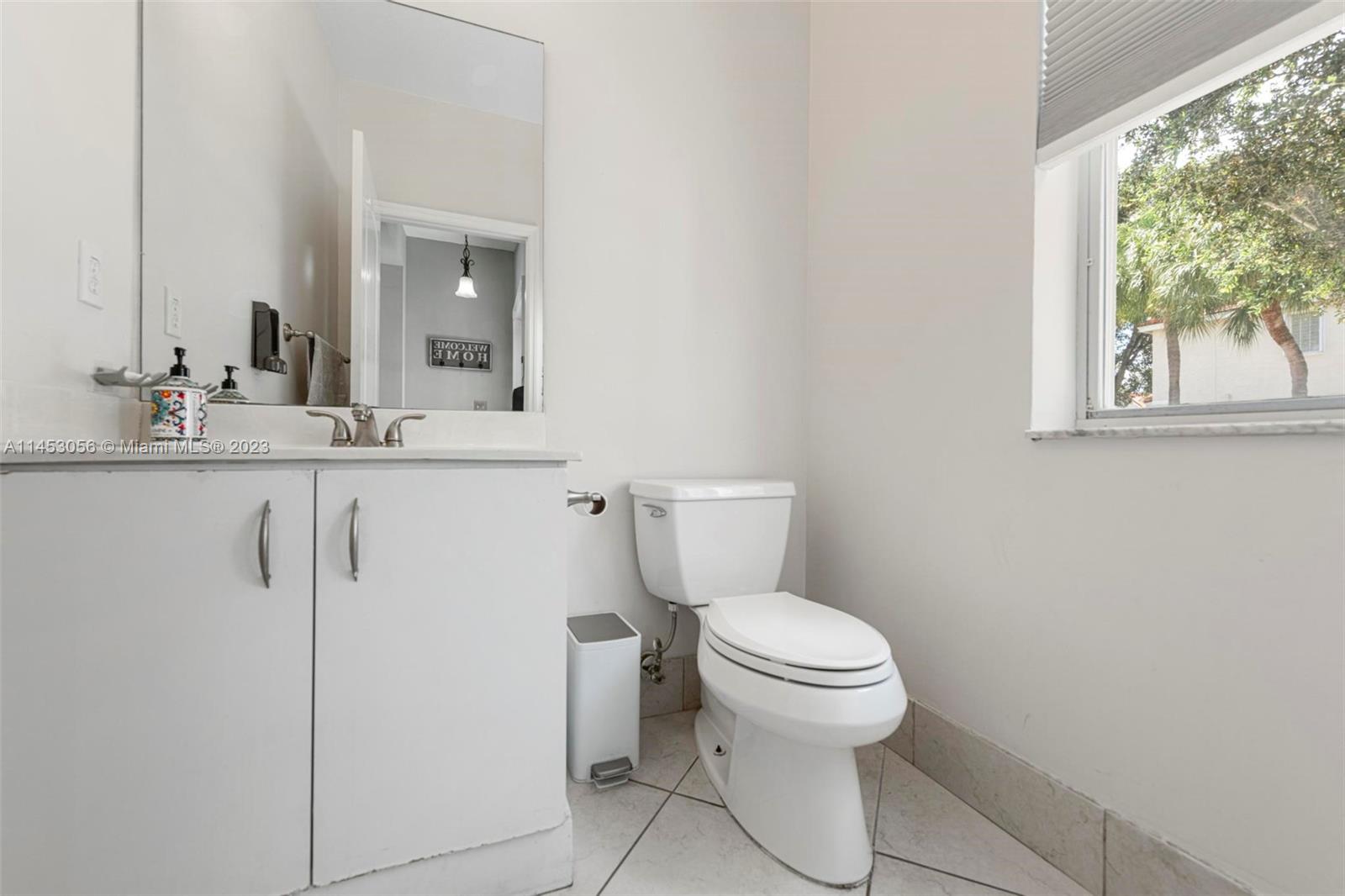 4175 Tree Top Road Cooper City, FL 33026 - Photo 17 of 39 a bathroom with a toilet sink and window