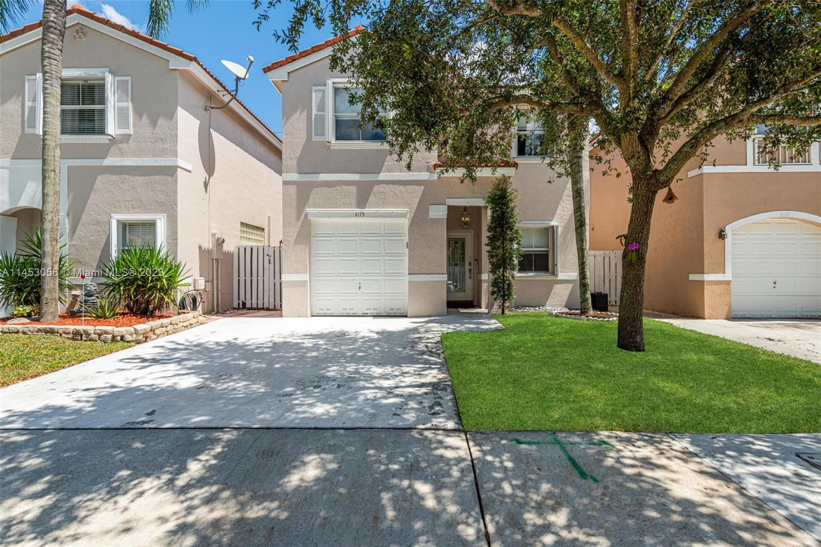 4175 Tree Top Road Cooper City, FL 33026 - Photo 2 of 39 a view of a house with a yard