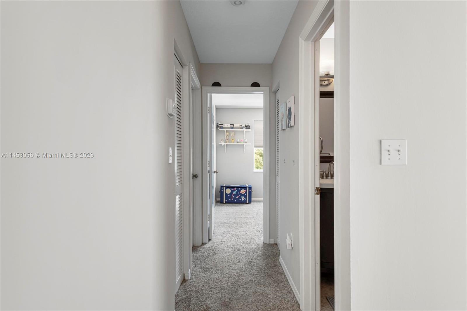 4175 Tree Top Road Cooper City, FL 33026 - Photo 23 of 39 a view of a hallway with wooden floor and a bathroom