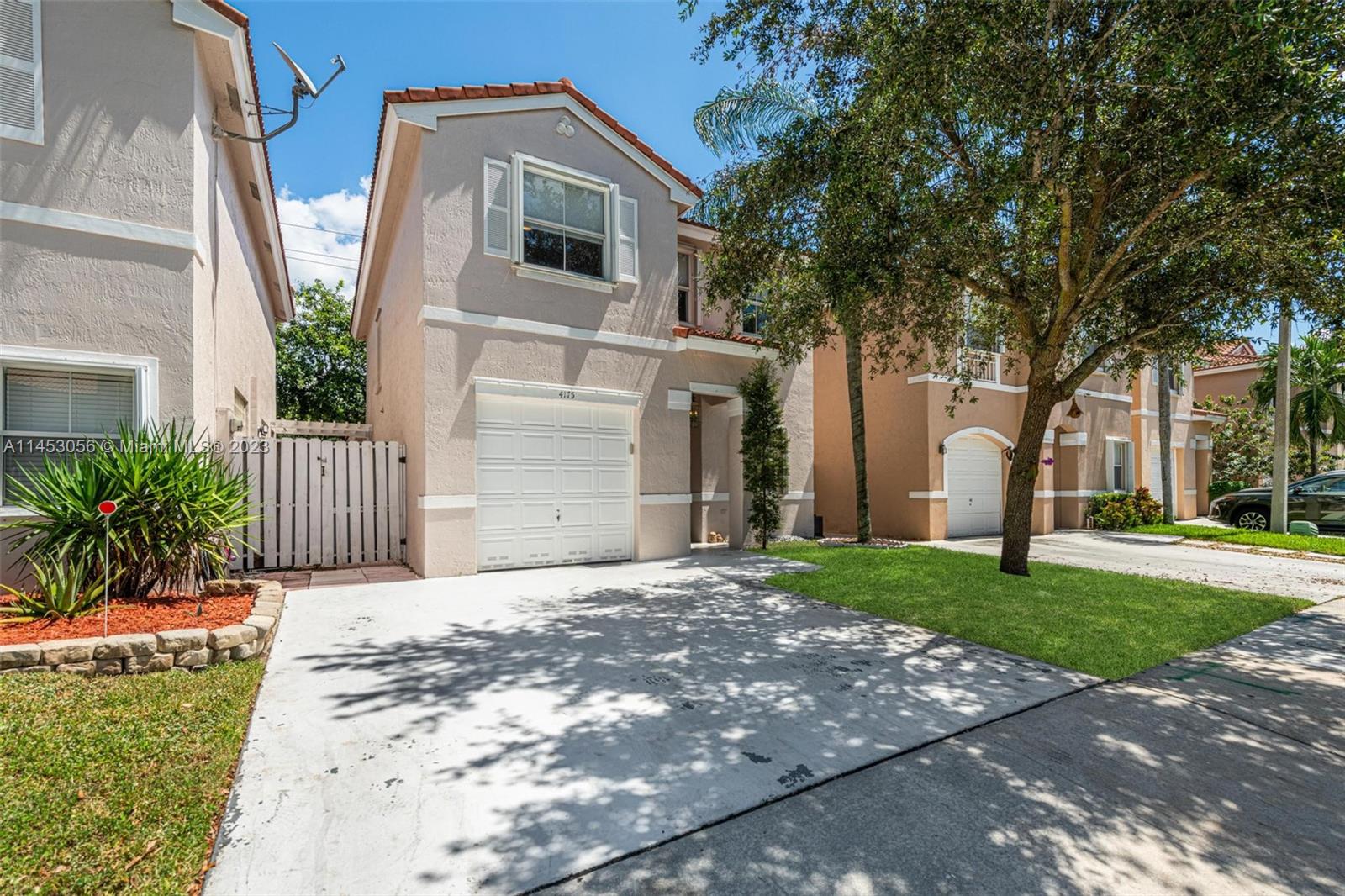 4175 Tree Top Road Cooper City, FL 33026 - Photo 3 of 39 a front view of a house with a yard