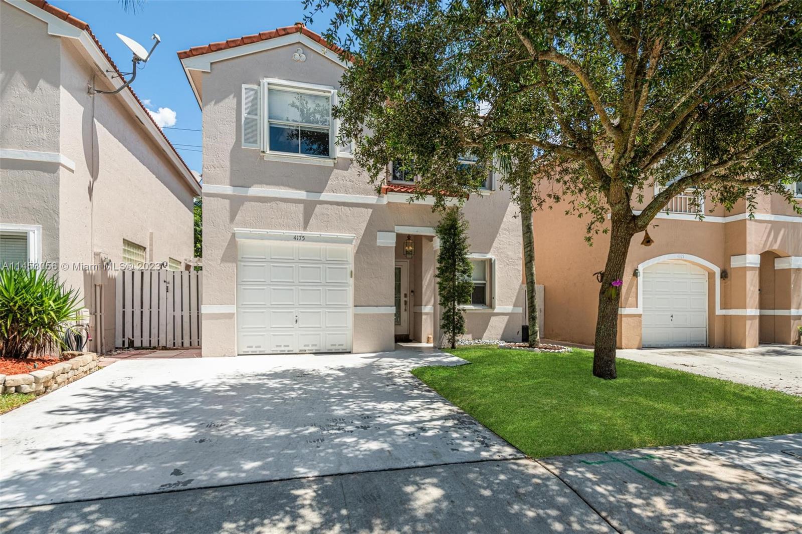 4175 Tree Top Road Cooper City, FL 33026 - Photo 4 of 39 a front view of a house with garden