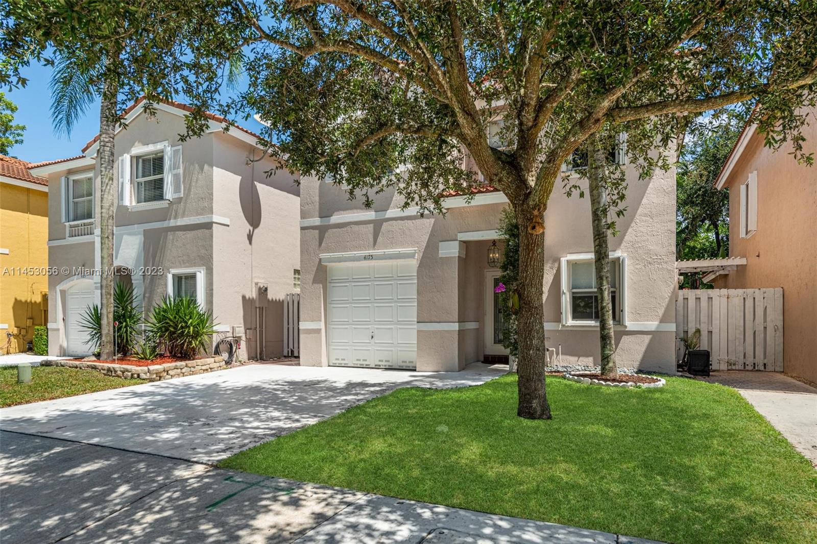 4175 Tree Top Road Cooper City, FL 33026 - Photo 5 of 39 a front view of a house with garden