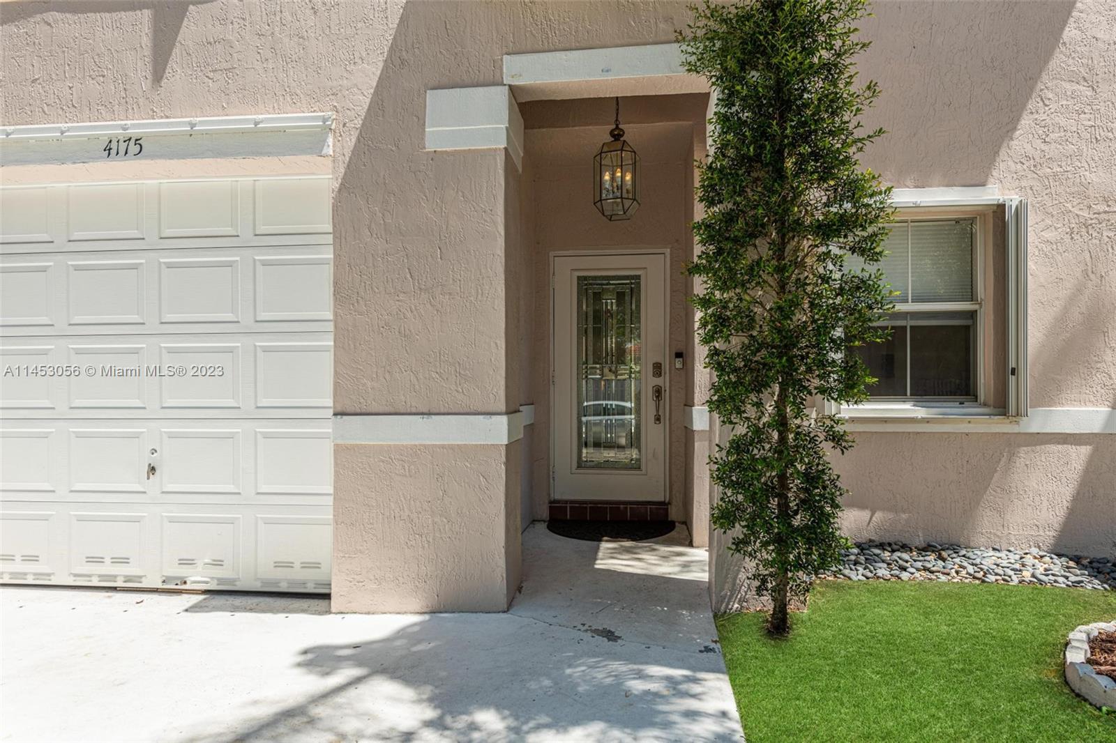 4175 Tree Top Road Cooper City, FL 33026 - Photo 6 of 39 a front view of a house with a yard