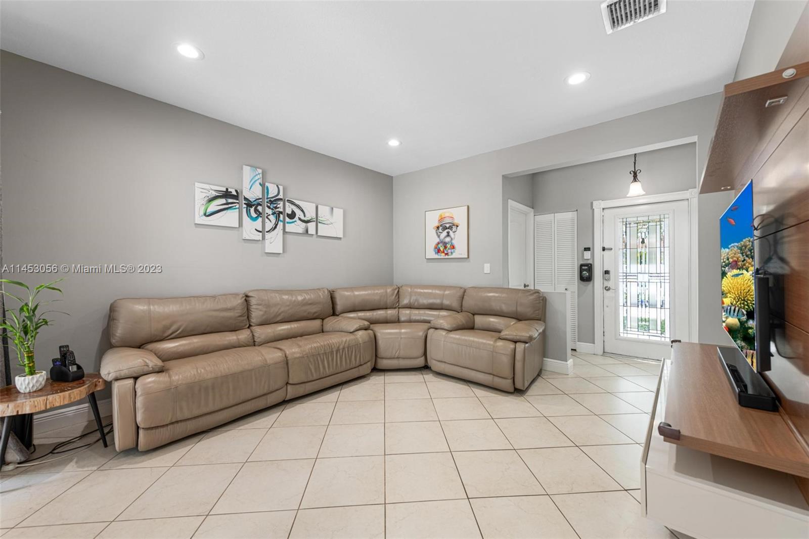 4175 Tree Top Road Cooper City, FL 33026 - Photo 10 of 39 a living room with furniture and a flat screen tv