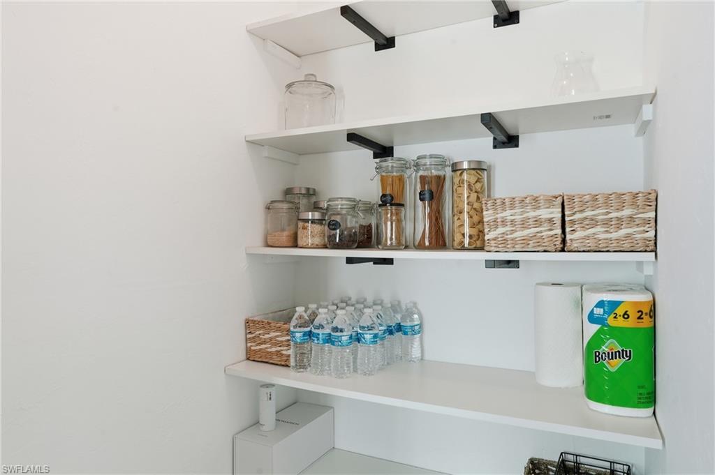 2828 Jackson Street, Unit H6 Fort Myers, FL 33901 - Photo 12 of 27 a room with kitchen island and stainless steel appliances