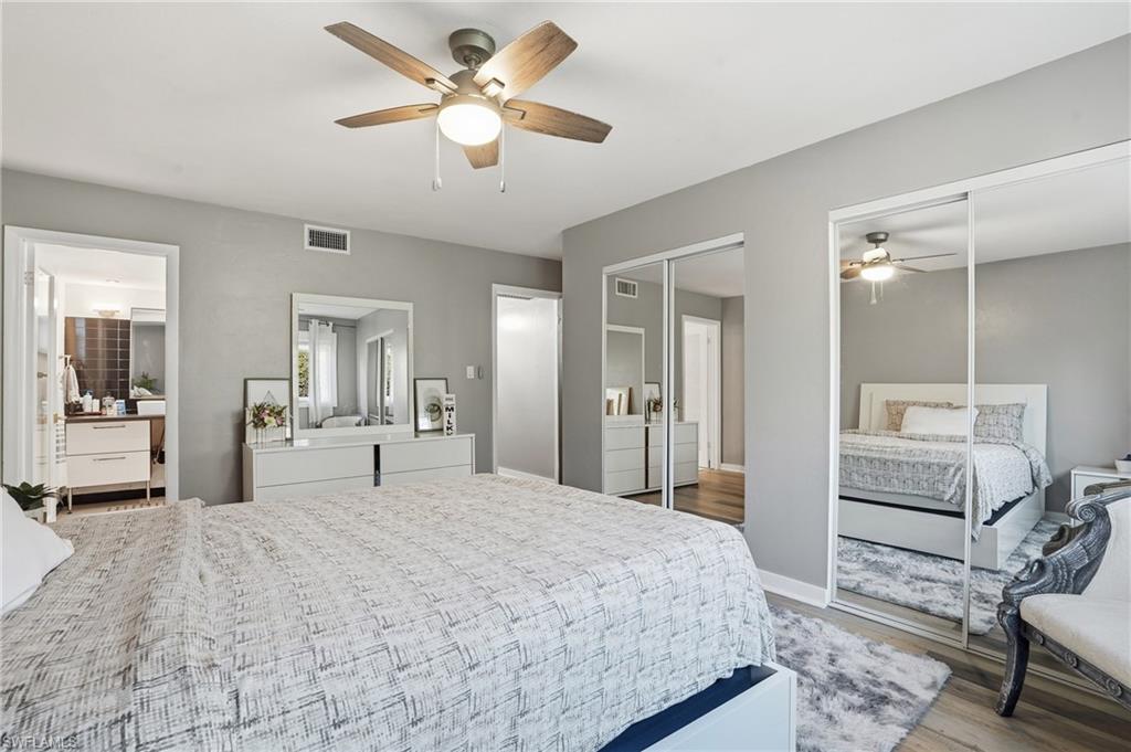 2828 Jackson Street, Unit H6 Fort Myers, FL 33901 - Photo 15 of 27 a bedroom with a bed and a chandelier