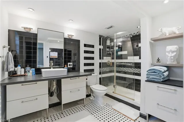a kitchen with a sink and white cabinets