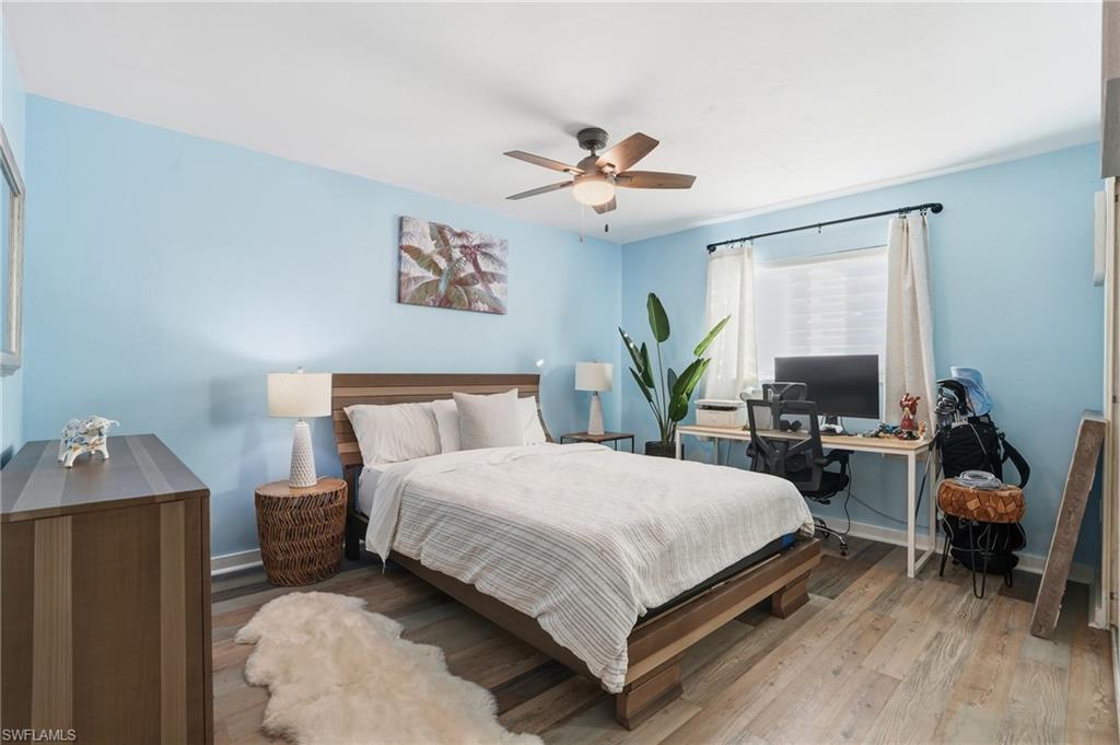 2828 Jackson Street, Unit H6 Fort Myers, FL 33901 - Photo 18 of 27 a bedroom with a bed and a chandelier