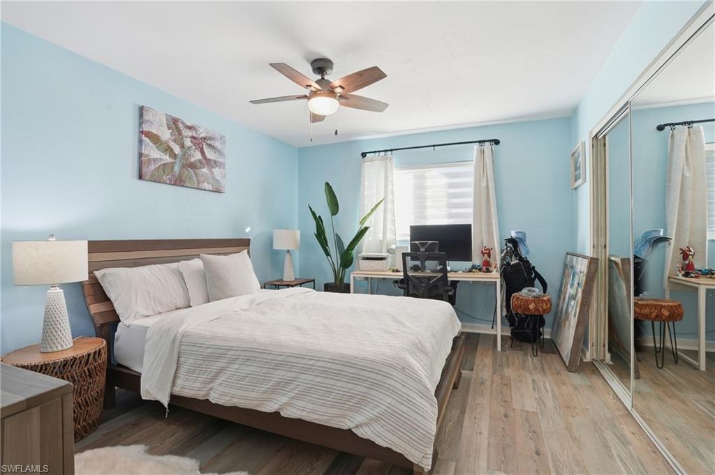 2828 Jackson Street, Unit H6 Fort Myers, FL 33901 - Photo 19 of 27 a bedroom with a bed a chandelier and a dresser