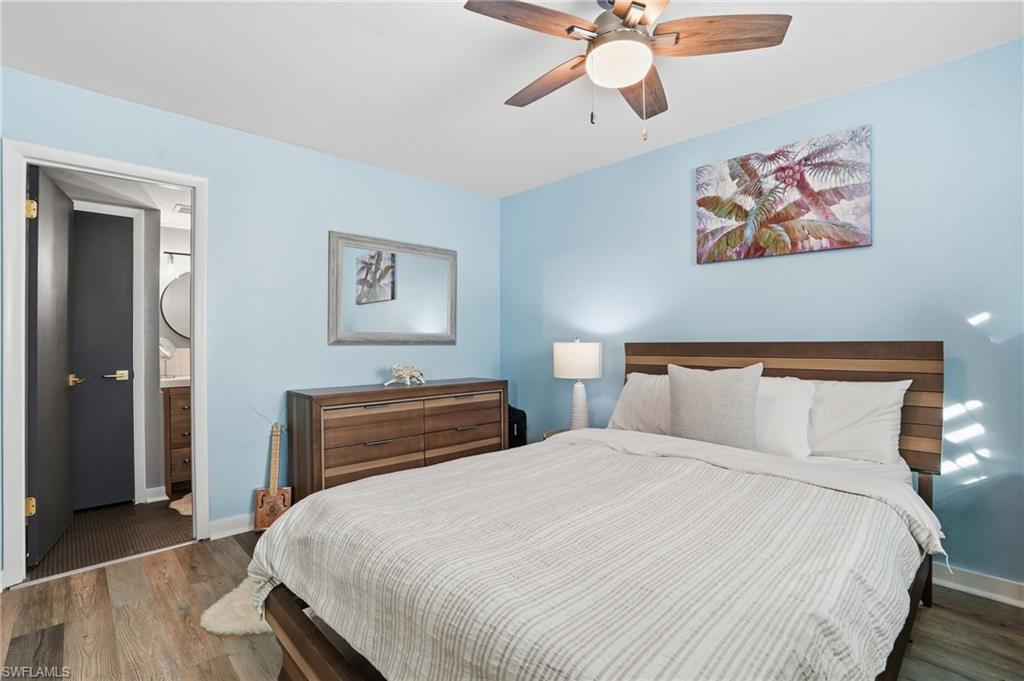 2828 Jackson Street, Unit H6 Fort Myers, FL 33901 - Photo 20 of 27 a bedroom with a bed and a chandelier