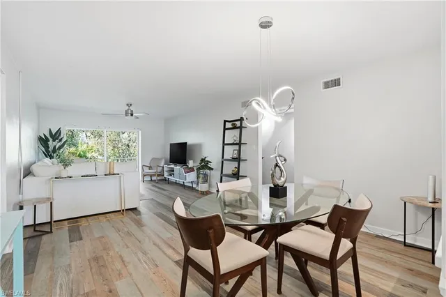 a kitchen with a table and a refrigerator