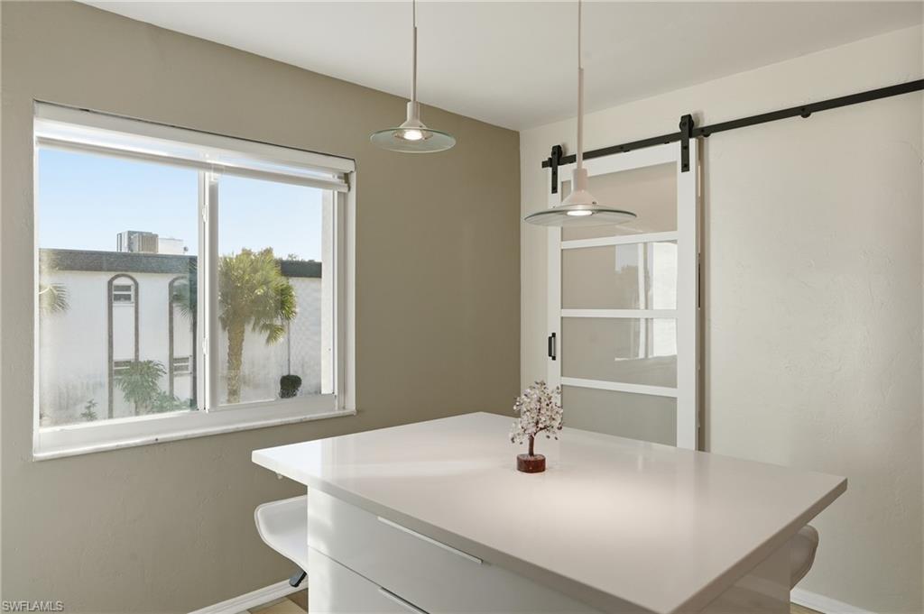 2828 Jackson Street, Unit H6 Fort Myers, FL 33901 - Photo 10 of 27 a kitchen with a table and a refrigerator