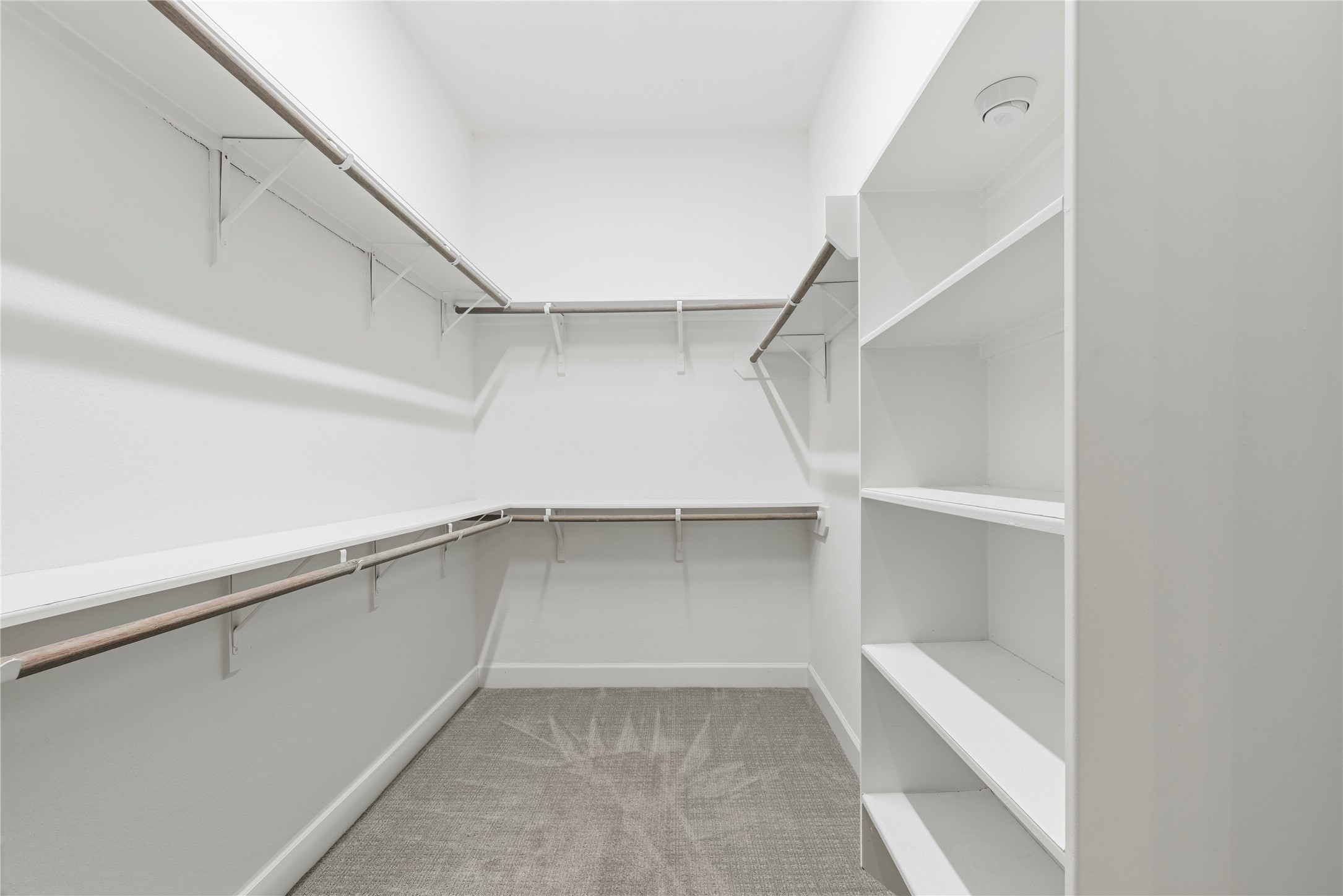 3438 Rich Radish Road Richmond, TX 77406 - Photo 12 of 25 Directly accessible from the primary bath, the walk-in closet is beautifully organized with an upgraded built-in shoe rack, extra clothes rods, and extensive shelving.