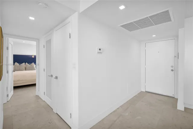 a bedroom with two beds and a night stand