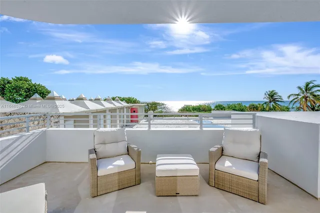 a roof deck with couches and potted plants