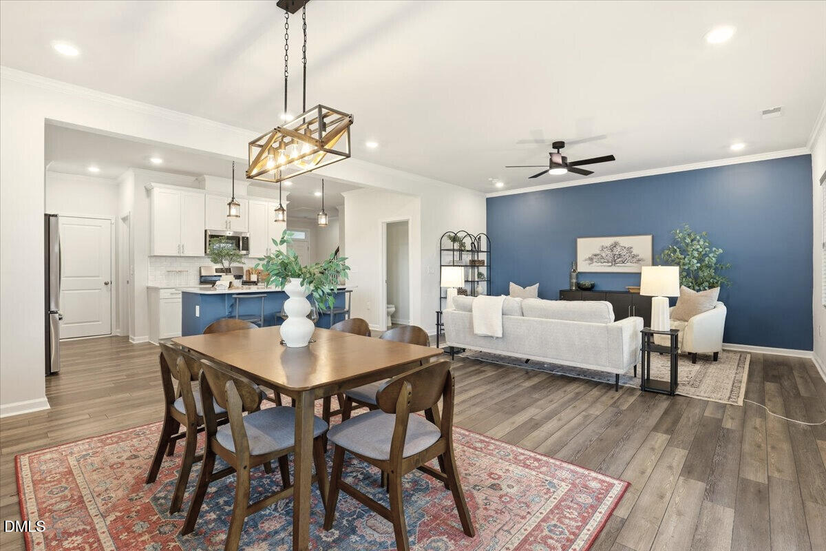 5052 Tura Street Raleigh, NC 27610 - Photo 13 of 47 a view of a dining room with furniture and wooden floor