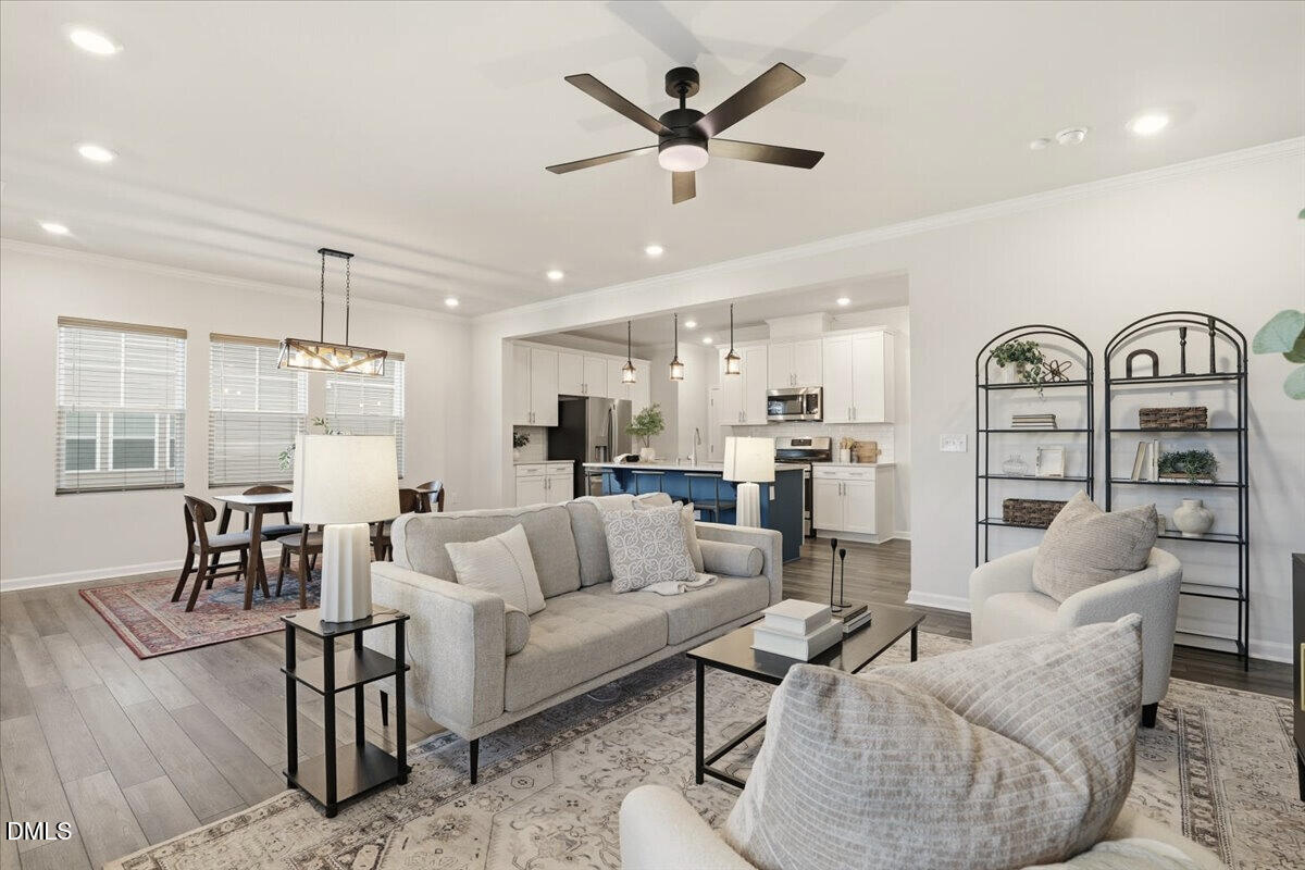 5052 Tura Street Raleigh, NC 27610 - Photo 14 of 47 a living room with furniture kitchen view and a chandelier