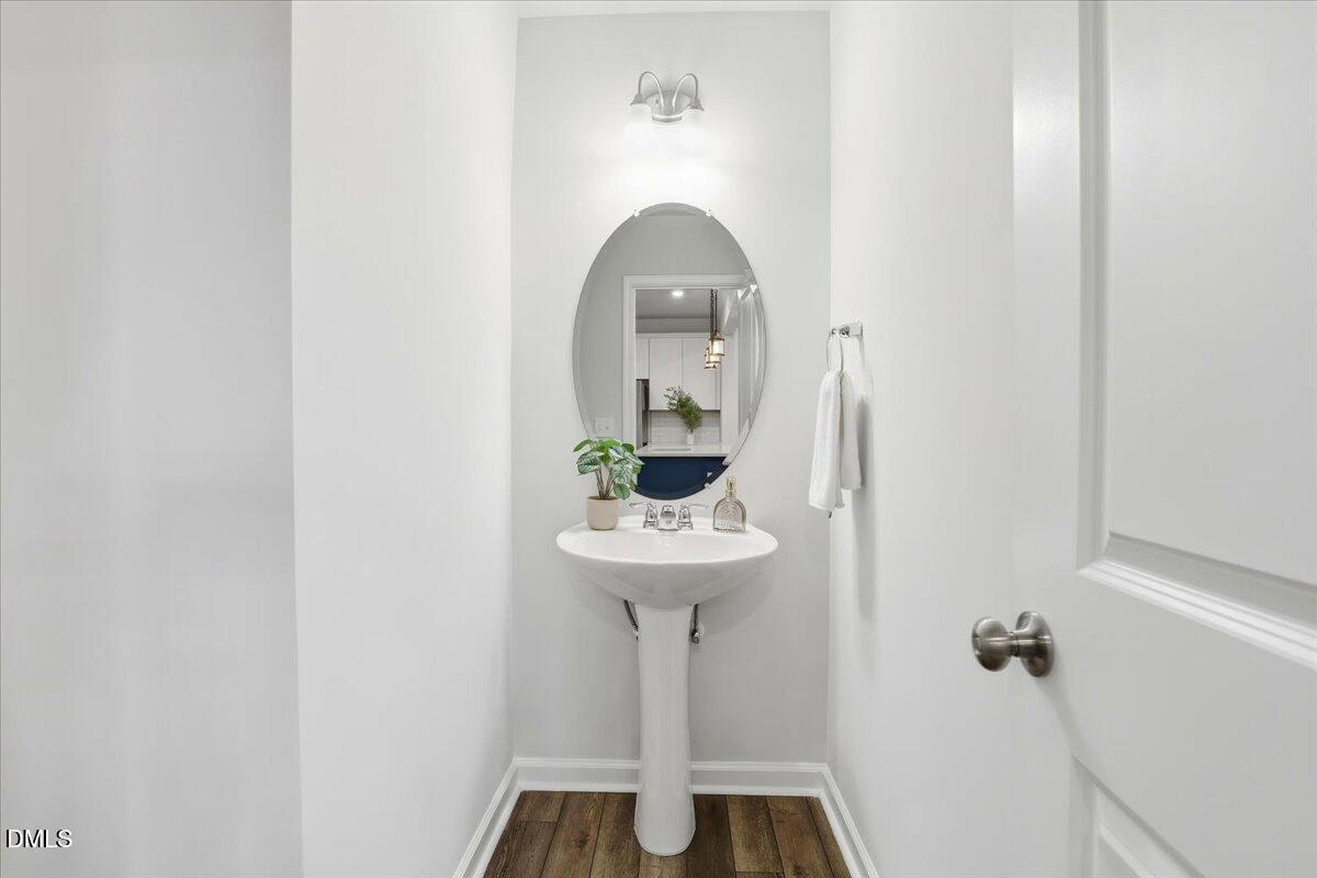 5052 Tura Street Raleigh, NC 27610 - Photo 15 of 47 a bathroom with a sink and a mirror