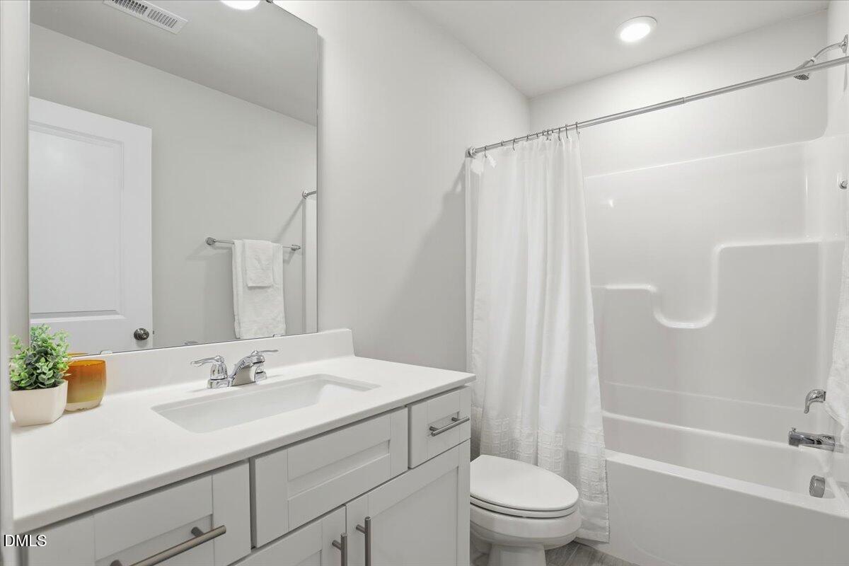 5052 Tura Street Raleigh, NC 27610 - Photo 23 of 47 a bathroom with a sink toilet and shower