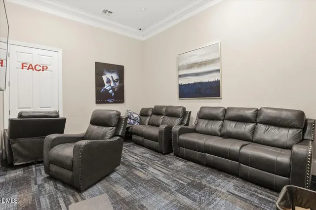 a view of an empty room with kitchen and a window