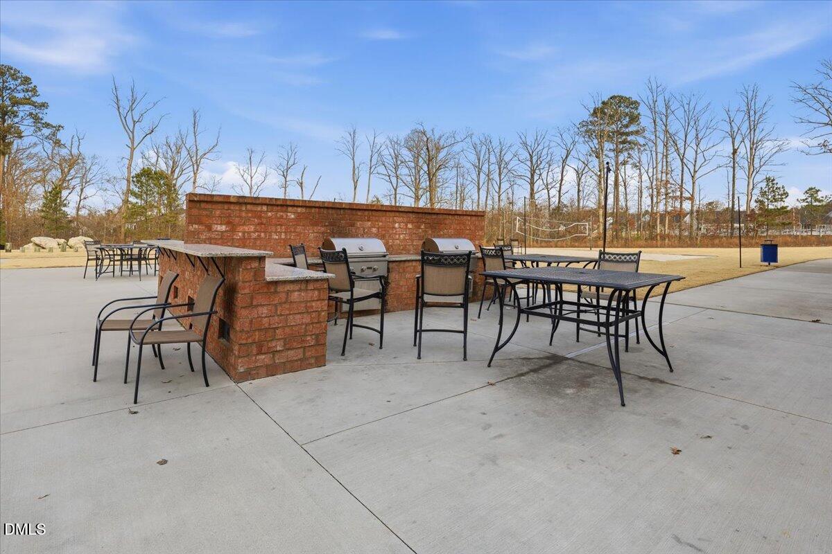 5052 Tura Street Raleigh, NC 27610 - Photo 37 of 47 a view of a patio with table and chairs and potted plants