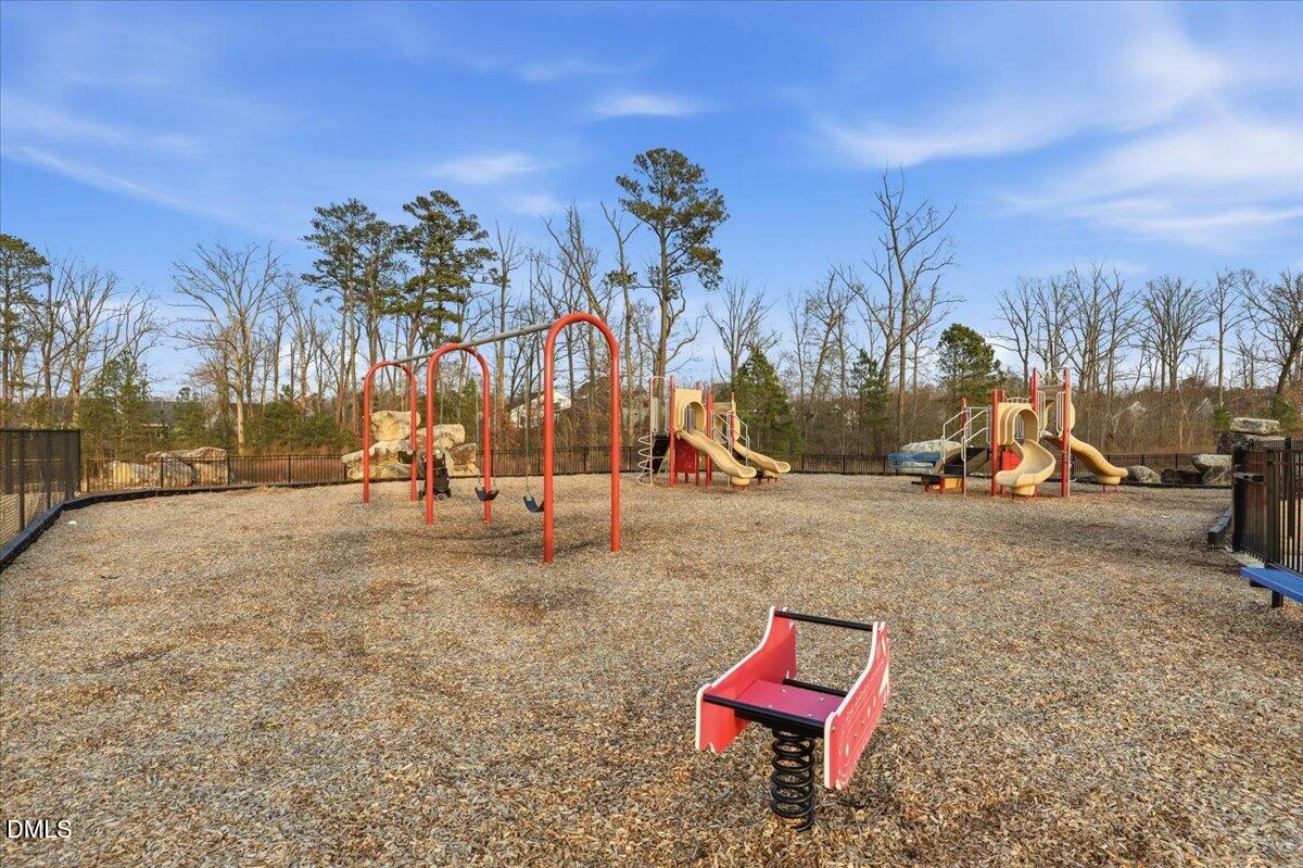 5052 Tura Street Raleigh, NC 27610 - Photo 38 of 47 a view of a park with swings and slides