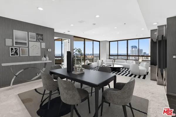 a view of a a dining room with furniture window and wooden floor