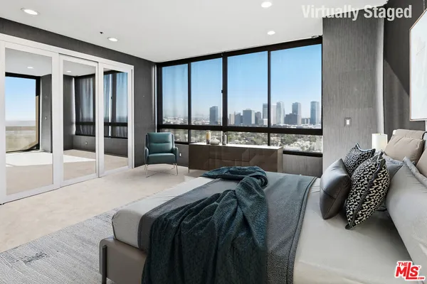a bed room with a bed and a large window